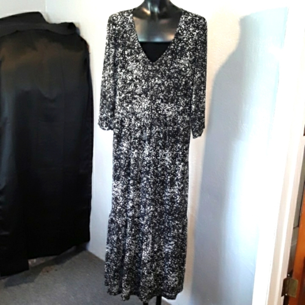 Black and white tiered maxi dress with long sleeves and slit size large no label